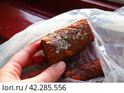 Raw smoked sausage became moldy while it was in a plastic bag. A mold or mould. The dust-like, colored appearance of molds is due to the formation of spores containing fungal secondary metabolites. Стоковое фото, фотограф Юлия Петровская / Фотобанк Лори