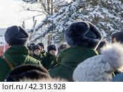 Maykop, Russia - January 13, 2024: parents and relatives stand on the parade ground at the taking of the military oath by recruits on a winter morning. Редакционное фото, фотограф Андрей С / Фотобанк Лори