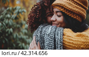 Two women in sweaters hug each other, care,Generative AI. Стоковое AI-изображение, AI-художник Анна Кривицкая / Фотобанк Лори