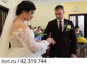 Невеста одевает кольцо жениху. Бракосочетание. (2023 год). Редакционное фото, фотограф Анатолий Матвейчук / Фотобанк Лори