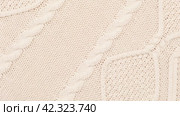 Soft Knitted Woolen Detailed Texture. Natural Fabric Closeup Knit Pattern. Beige Knitwear, Warm Cashmere Surface. Rotation, Macro. Cozy Creamy Textile Background. Clothes Production. Melange Yarn. 4K. Стоковое видео, видеограф Марина Демидюк / Фотобанк Лори
