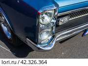 LINTHE, GERMANY - MAY 27, 2023: The fragment of muscle car Pontiac GTO, (first generation). Die Oldtimer Show 2023. Редакционное фото, фотограф Sergey Kohl / Фотобанк Лори