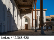 View of the courtyard of the Bahauddin Naqshbandi Memorial Complex and the entrance to the Amir Muzaffarkhan Mosque on a sunny day, Bukhara, Uzbekistan. Стоковое фото, фотограф Ula Ulachka / Фотобанк Лори