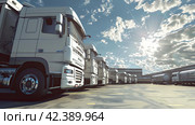 Large white cargo trucks standing in a row under a blue cloudy sky near a warehouse on loading. Cargo business concept. Стоковое AI-изображение, AI-художник Ярославский Максим / Фотобанк Лори