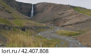 Hengifoss Waterfall with Foliage in foregroud, East Iceland. Стоковое видео, видеограф Igor Tichonow / Фотобанк Лори