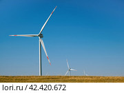 Wind turbines in the field against a blue sky in summer. Стоковое фото, фотограф Светлана Семёновская / Фотобанк Лори