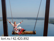 Kozlovsky district,Chuvashia/Russian Federation - 08.17.2022 - a woman in Chuvash national dress at the tourist site "Bird Flight" Редакционное фото, фотограф Андриян Григорьевич Чаркин / Фотобанк Лори