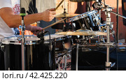 Drummer behind a drum kit. A drum set including snails, bass drum, tom-toms, cymbals and hi-hat, ready to play a rhythm. Стоковое фото, фотограф Воловодов Владимир / Фотобанк Лори