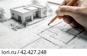 The architect draws the layout of a modern house,Generated by AI. Стоковое AI-изображение, AI-художник Siarhei Starastau / Фотобанк Лори