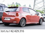 Orange Fiat Grande Punto three door hatchback parked on the street in the city (2021 год). Редакционное фото, фотограф Константин Григорьев / Фотобанк Лори