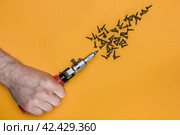 Male hand holds a screwdriver on a yellow background. A scattering of black screws. flat lay for construction tools concept. Top view. Стоковое фото, фотограф Константин Григорьев / Фотобанк Лори