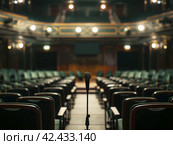 Empty Theater with Center Stage Microphone. Стоковое AI-изображение, AI-художник Кирилл Черезов / Фотобанк Лори