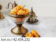 Muslim holiday sweets. Moroccan chebakia, chak-chak and handmade nath. Homemade Muslim sweet baked goods. Стоковое фото, фотограф Оксана Медведева / Фотобанк Лори