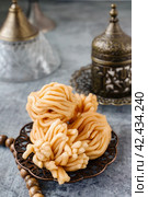 Muslim holiday sweets. Moroccan chebakia, chak-chak and handmade nath. Homemade Muslim sweet baked goods. Стоковое фото, фотограф Оксана Медведева / Фотобанк Лори