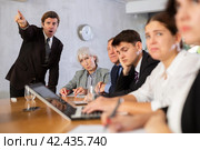 Angry boss scolding subordinates at meeting in office. Стоковое фото, фотограф Яков Филимонов / Фотобанк Лори