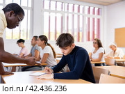 African american teacher prompts an adult student to solve equation. Стоковое фото, фотограф Яков Филимонов / Фотобанк Лори