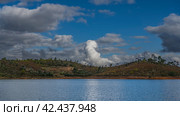A beautiful blue lake. Trees grow on the coastal hills. Clouds in the azure sky. Reflection on calm water. Madagascar. Mantasoa lake. Стоковое фото, фотограф Вера Ивановна Кубарева / Фотобанк Лори