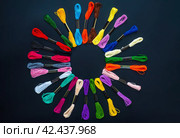 Many skeins of mouline thread for embroidery on a row in circle on black background. Стоковое фото, фотограф Татьяна Терехина / Фотобанк Лори