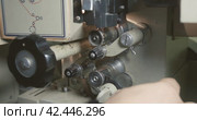 Process of charging 35mm cine-film roll in the mechanism of film projector. Close-up operator hands. Стоковое видео, видеограф EStarodubov / Фотобанк Лори