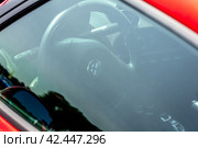 LINTHE, GERMANY - MAY 27, 2023: The interior through glass of sports car Alfa Romeo 4C, close-up. Die Oldtimer Show 2023. Редакционное фото, фотограф Sergey Kohl / Фотобанк Лори