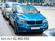 Blue BMW X6 xDrive40d parked along the street. Front view of premium SUV car. Редакционное фото, фотограф Константин Григорьев / Фотобанк Лори