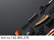 An Assortment of Professional Hairdressing Tools Laid Out on a Dark Surface. Стоковое фото, фотограф Сергей Толмачёв / Фотобанк Лори