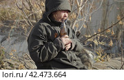 Бомж, бездомная женщина бродяга. Homeless unkempt woman in a temporary place is drinking beer. Стоковое видео, видеограф EStarodubov / Фотобанк Лори