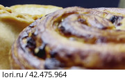 Various types of homemade pastries rotate on a plate on a dark background. Close-up shooting. Стоковое видео, видеограф Ярославский Максим / Фотобанк Лори