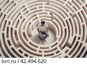 Man stuck in the middle of maze. Generate ai. Стоковое AI-изображение, AI-художник Иван Рябоконь / Фотобанк Лори