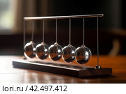 Newtons cradle wooden table sphere. Generate Ai. Стоковое AI-изображение, AI-художник Иван Рябоконь / Фотобанк Лори