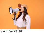 Girl megaphone speak on orange background. Generate Ai. Стоковое AI-изображение, AI-художник Иван Рябоконь / Фотобанк Лори