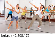 Group of active women practicing energetic dance in a studio. Стоковое фото, фотограф Яков Филимонов / Фотобанк Лори