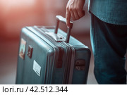 Person holding travel suitcase. Generate ai. Стоковое AI-изображение, AI-художник Иван Рябоконь / Фотобанк Лори
