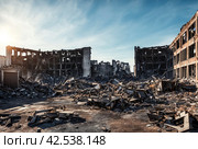 Remains of destroyed industrial building with internal communications. Demolition of building on territory plant. Background with dilapidated building and fragments of bricks and construction debris. Стоковое AI-изображение, AI-художник Aleksandr Golubev / Фотобанк Лори