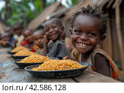 The problem of poverty and inequality. Happy african kids eating some sorghum porridge in village outdoor. Стоковое AI-изображение, AI-художник Ирина Михайличенко / Фотобанк Лори