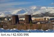 Apatity, Murmansk region, Russia, March 12, 2024: Territory of industrial area of Second apatite-nepheline concentration factory in north of city at foot of Vudyavrchorr Khibin mountain. Редакционное фото, фотограф Алексей Антипов / Фотобанк Лори