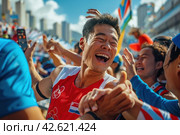 Ecstatic Asian male athlete celebrates victory with teammates and fans. Стоковое AI-изображение, AI-художник Юрий Поздников / Фотобанк Лори