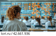 Female scientist in lab coat looking at a screen with scientific data. Стоковое AI-изображение, AI-художник Юрий Поздников / Фотобанк Лори