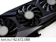 A black and white video card on a white background. Fans and the graphics card case. Computer accessories. Стоковое фото, фотограф Valeriy Lushchikov / Фотобанк Лори