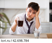young man suffering from hangover. Стоковое фото, фотограф Яков Филимонов / Фотобанк Лори
