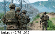 A military outfit guards the border of the forbidden zone. Стоковое AI-изображение, AI-художник Ярославский Максим / Фотобанк Лори