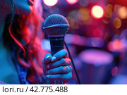 A music artist sings into a purple microphone on stage. Стоковое AI-изображение, AI-художник Юрий Поздников / Фотобанк Лори