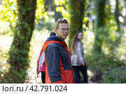 Man in Red and Black Jacket Walking Through Forest. Стоковое фото, фотограф Константин Шишкин / Фотобанк Лори