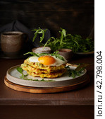 Homemade keto waffles with fried egg, flying arugula, mozzarella cheese. Levitation. Chaffles, keto. Стоковое фото, фотограф Natalia Gdovskaia / Фотобанк Лори