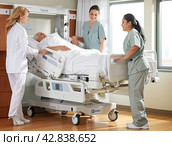 Team medical doctor pushing stretcher gurney bed corridor with female patient in hospital. Health care Concept. Стоковое AI-изображение, AI-художник Ярославский Максим / Фотобанк Лори