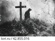 A dark and expressive black and white photograph. In the center of the frame in the foreground is a wooden cross, which is a classic symbol of the Christian faith. Behind the cross, on the ground, stands the figure of a man in dark clothing with a bowed head, which can symbolize sadness, mourning or prayer. Стоковое AI-изображение, AI-художник Анна Кривицкая / Фотобанк Лори