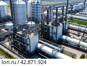 Industrial plant of petroleum, chemical, hydrogen or ammonia. Industrialization zone with pipeline and pipe rack. Manufacturing and industry technology concept. Gen ai illustration. Copy ad text space. Стоковое AI-изображение, AI-художник Aleksandr Golubev / Фотобанк Лори