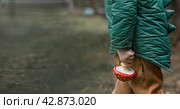 A child and a fly agaric. The boy with the fly agaric. A dangerous poisonous mushroom in the hands of a child. Mushroom poisoning, microdosing, eating herbal medicine. Стоковое фото, фотограф Photojuli / Фотобанк Лори
