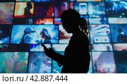 A person watching a video wall with multimedia image. Стоковое AI-изображение, AI-художник Ярославский Максим / Фотобанк Лори