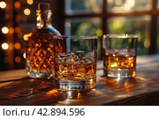 Two glasses and bottle of whiskey on a wooden table, Стоковое AI-изображение, AI-художник Анна Кривицкая / Фотобанк Лори